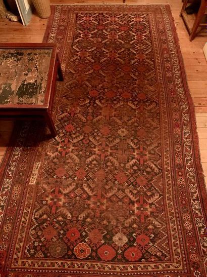 null Wool oriental rug decorated with stylized red, blue and beige motifs.
330 x...