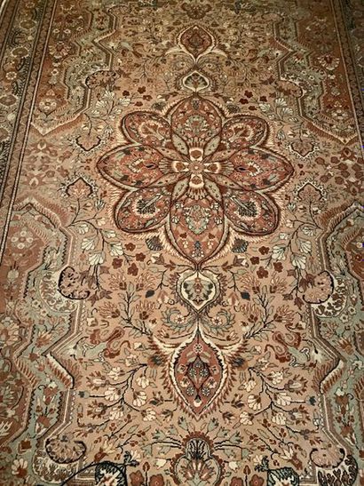 null Wool oriental rug decorated with a central rosette with an ochre background...