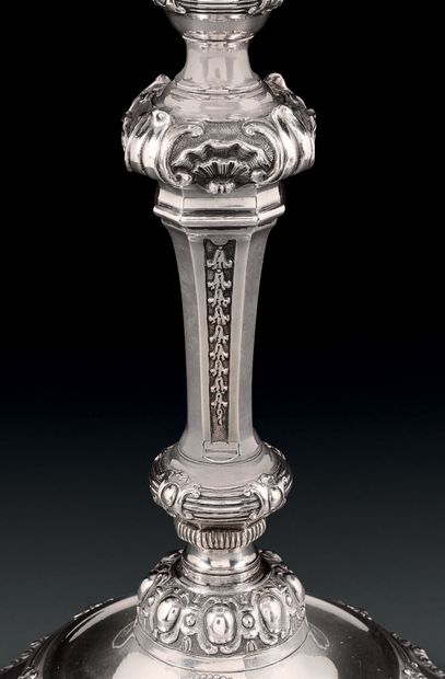 null Pair of silver torches and two candlesticks, standing on a round base with contours...