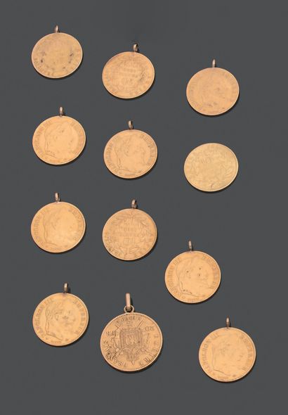 null FRANCE. Twelve yellow gold coins: eleven of ten francs mounted in charm (one...