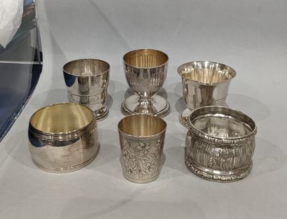 null 
Set in silver (950): three egg cups with stylized decoration; a napkin ring...