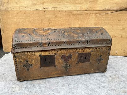 null 
Leather chest on wood core stitched with nails drawing reserves, volutes, rhombuses...