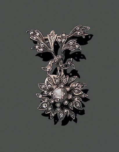 null 18K (750) yellow gold and 950 silver brooch, featuring a flower held by a knotted...