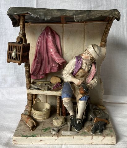 null Group in polychrome earthenware representing a cobbler in his shop. Small a...