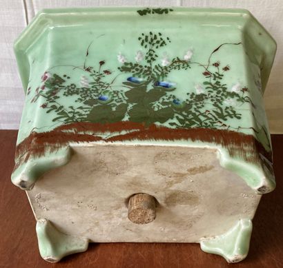 null Porcelain planter with cut sides decorated with trees in flowers on a celadon...