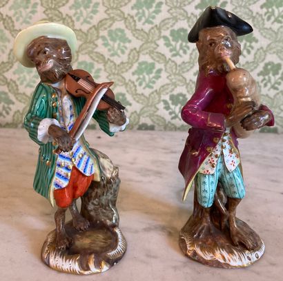 Pair of polychrome porcelain statuettes of...