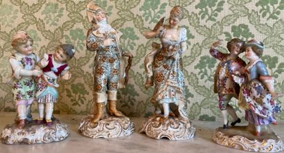 Pair of polychrome porcelain statuettes enhanced...