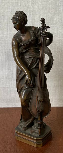 null Statuette in patinated bronze representing a cellist, cast by Thiebaut Frères....