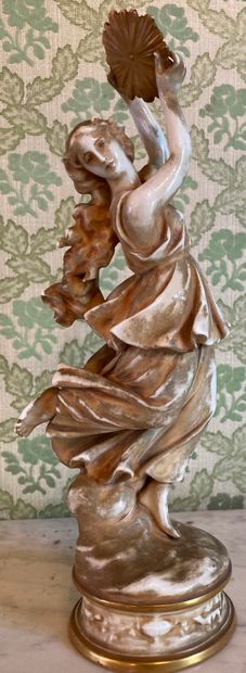 null Porcelain statuette enhanced with gilding representing a dancer dressed in antique...