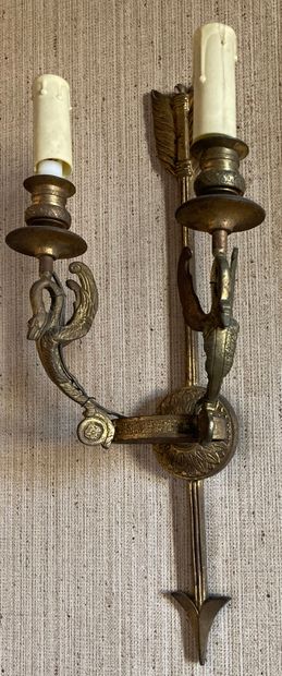 null Pair of wall sconces in gilded cast bronze, the shaft showing an arrow applied...