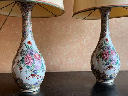null Pair of porcelain bottle vases with polychrome floral decoration in reserves...