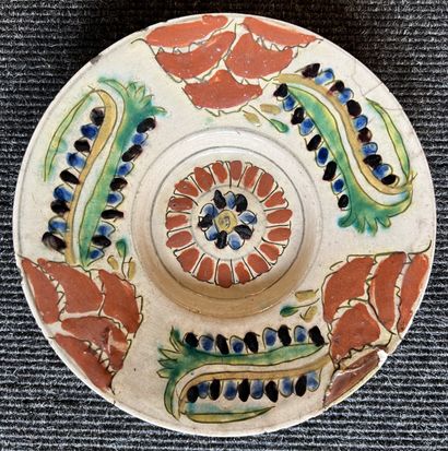 null Small siliceous ceramic cup on heel decorated with stylized motifs in red, green,...