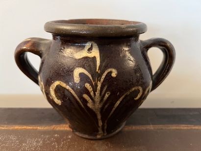 null Earthenware pot with two handles, decorated with leafy branches and flowers...