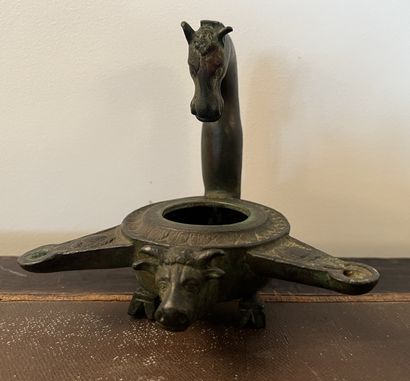 null Oil lamp tripod in bronze, the catch representing a horse's head, the tank with...