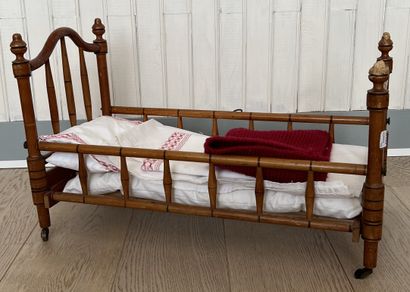null Doll's bed in natural wood in imitation of bamboo, the headboards with spindles...