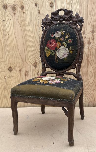 null Oak chair carved with vine shoots, the back decorated with scrolls of foliage...