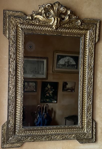 null Mirror with a gilded wood frame decorated with friezes of foliage, surrounding...