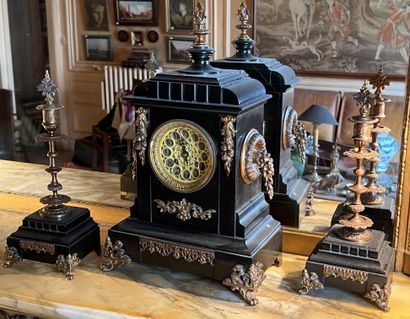 null Black marble and ormolu mantel set, including a clock and a pair of torches....