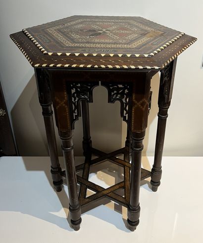null Hexagonal pedestal table in native wood marquetry, bone and blackened wood fillets....
