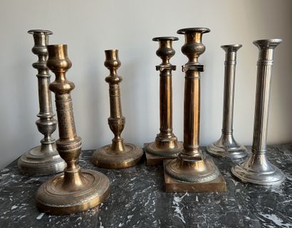null Two pairs of brass torches, one featuring columns with capitals, the other decorated...