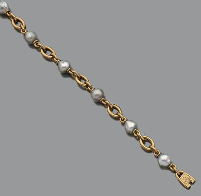 Bracelet en or jaune 18K (750) articulé d'anneaux...