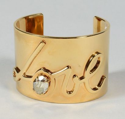 LANVIN Bracelet manchette ouvert en métal doré «Love», orné d'un strass à l'imitation...