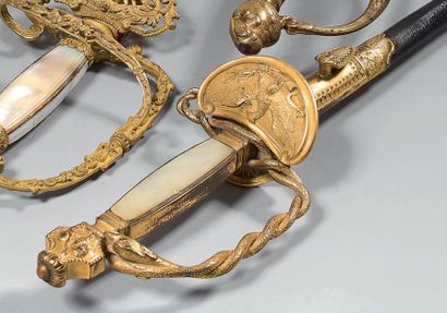 null A curious senior officer's sword, a chiseled and gilded brass guard, a keyboard...
