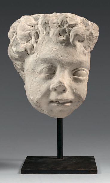 A chubby putto head with a marble wall lamp...