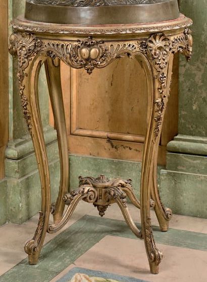 Carved and gilded wooden pedestal table with...