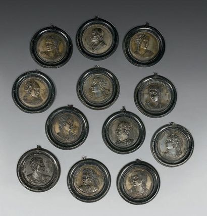 null A series of twelve circular lead medallions representing the profiles of three...