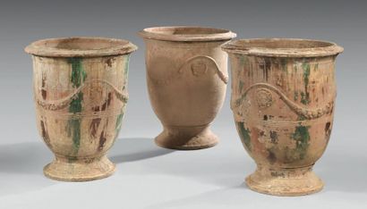 null Meeting of three bell-shaped enamelled terracotta vases; the bellies with garlands...