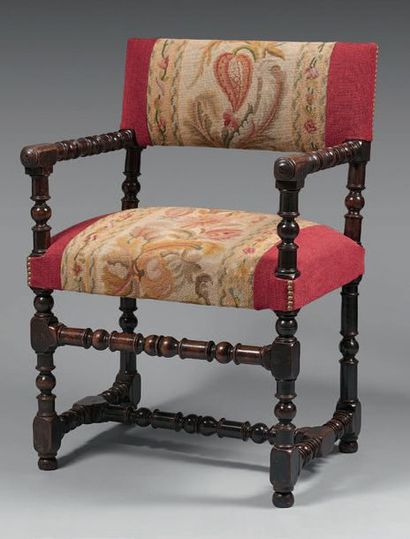 null Armchair in carved and turned walnut. Small flat backrest with a rectangular...