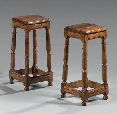 null Pair of molded oak cantor stools with trapezoidal base joined by a belt spacer;...