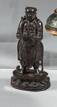 CHINE Bronze Shancai statue with brown patina and traces of gold lacquer, standing...