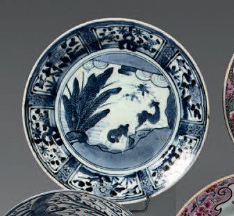 CHINE Circular porcelain plate, decorated in blue underneath covered with flowers...