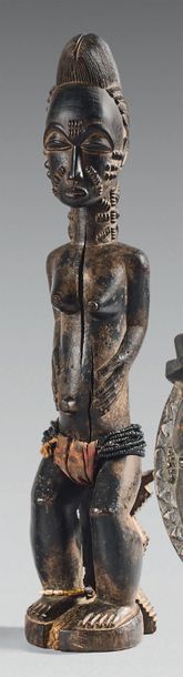 null Baule Statuette. (Côte d'Ivoire). The female subject is represented sitting...