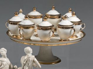 Duban, à PARIS Circular display on pedestal and nine porcelain cutlery juice jars,...