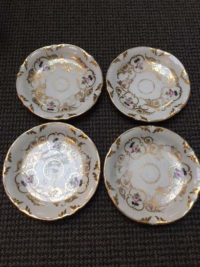 PARIS Four cups and their porcelain saucers decorated with polychrome roses in golden...