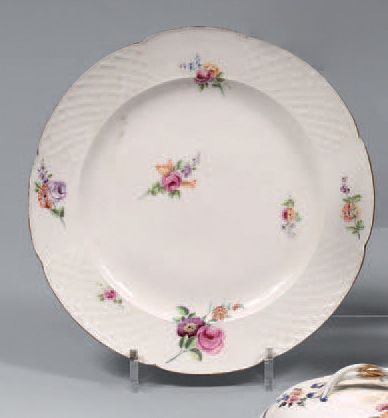 SÈVRES Polylobed plate in soft porcelain decorated in polychrome flowers. The wing...
