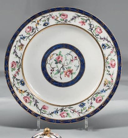 SÈVRES Circular plate in soft porcelain, decorated in polychrome with a garland of...