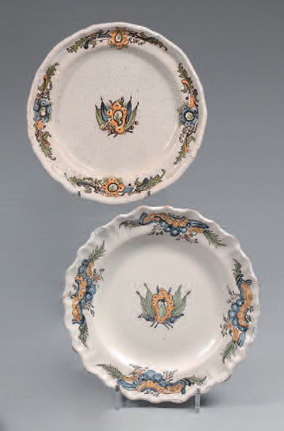 MOUSTIERS Two plates with different curved borders in earthenware with polychrome...