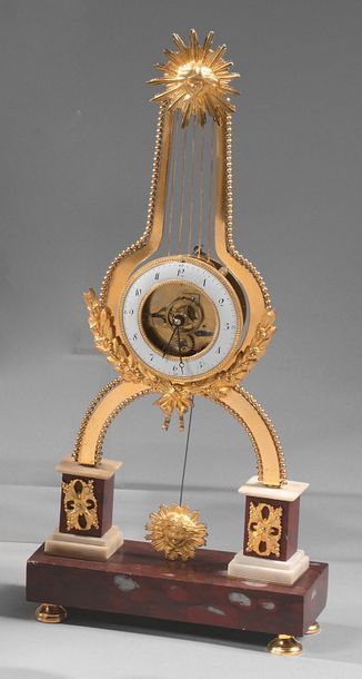 null Small gilt bronze, white and red Morello cherry marble "skeleton" clock; the...