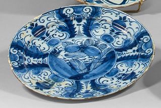DELFT Two earthenware plates with blue monochrome decoration. The first one with...