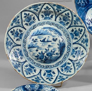 DELFT Earthenware umbilical dish with blue monochrome decoration of a boat in a central...