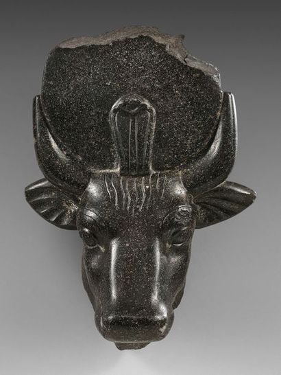 null Head of Apis crowned with the solar disc between the horns and a large erect...