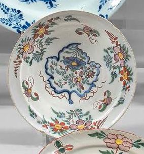DELFT Pair of earthenware plates with polychrome decoration of flowers, the border...