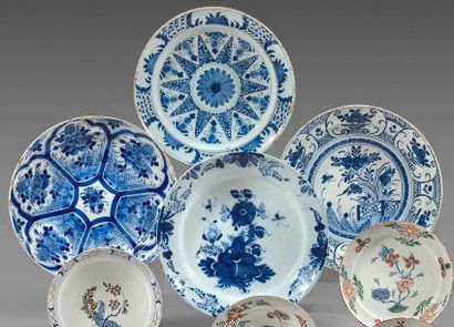 DELFT Four earthenware dishes decorated in blue with various floral motifs: star-shaped...