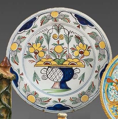 DELFT Circular earthenware dish with polychrome decoration of a flowered vase framed...