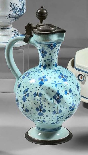 Hanau Covered earthenware jug in the shape of a baluster with a blue monochrome decoration...