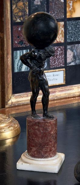 null Bronze figure with black patina representing Atlas, red marble base.
Italy,...